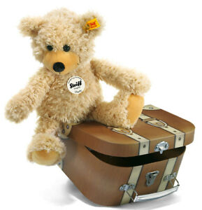 charly dangling teddy bear in suitcase